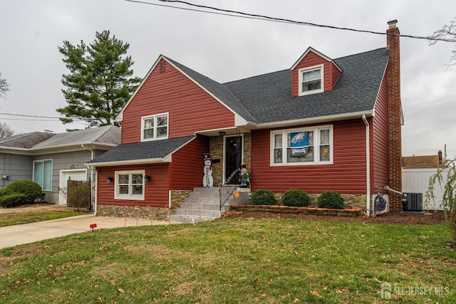 view of front of home with central AC and a front lawn