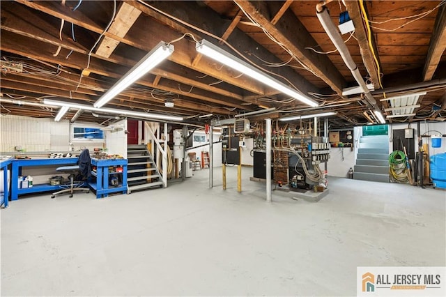 unfinished below grade area with stairway and a water pressure tank