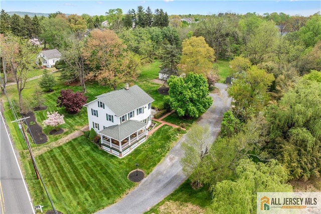 view of subject property featuring a heavily wooded area
