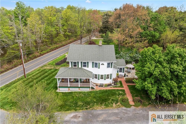 view from above of property with a heavily wooded area
