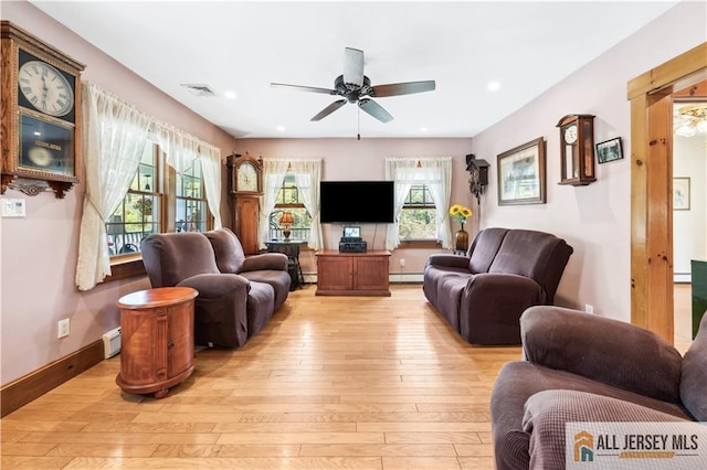 living room featuring light wood-type flooring, a ceiling fan, a baseboard radiator, plenty of natural light, and recessed lighting