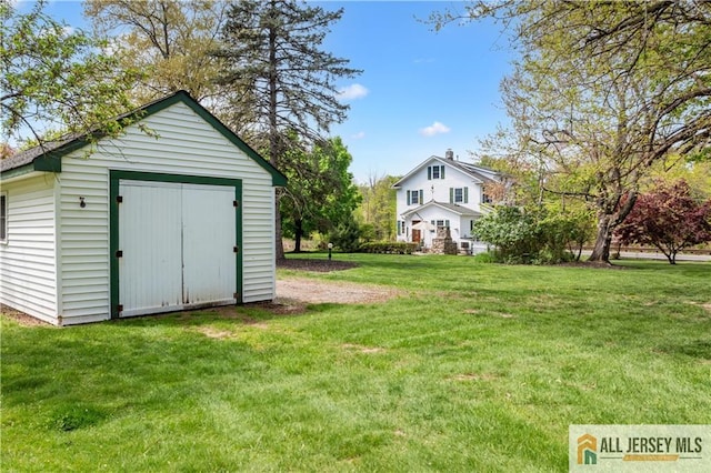 view of grassy yard with a shed and an outdoor structure