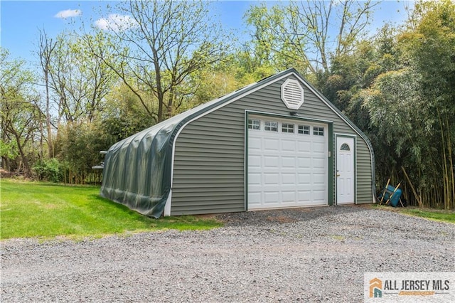 detached garage with gravel driveway