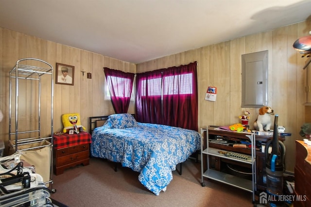 carpeted bedroom with electric panel and wooden walls