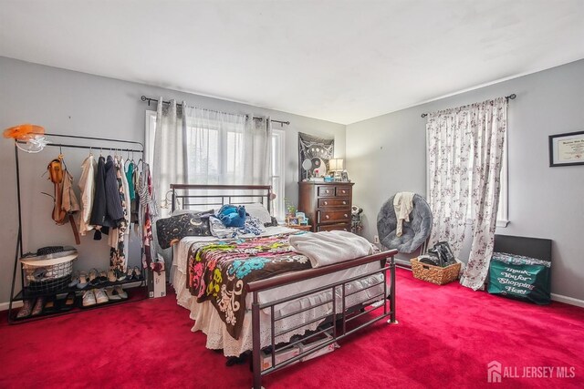bedroom with carpet floors and baseboards