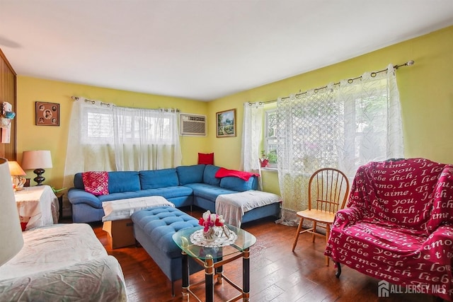living area with plenty of natural light, hardwood / wood-style floors, and an AC wall unit