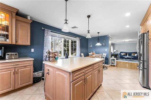 kitchen featuring light tile patterned floors, visible vents, freestanding refrigerator, and open floor plan