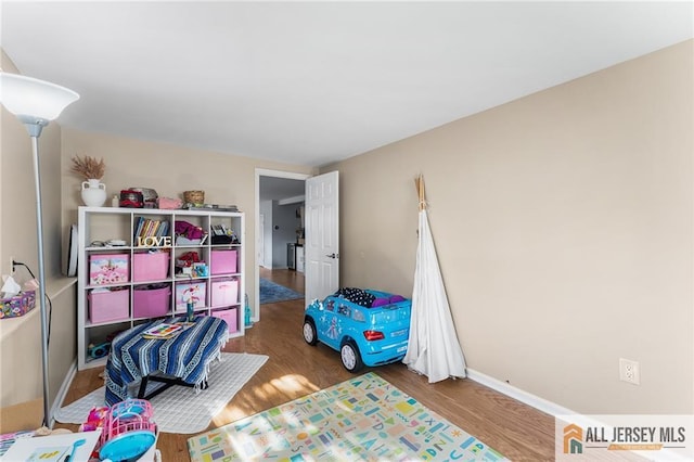 game room featuring baseboards and wood finished floors