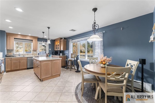 kitchen featuring visible vents, plenty of natural light, light countertops, stainless steel dishwasher, and a center island