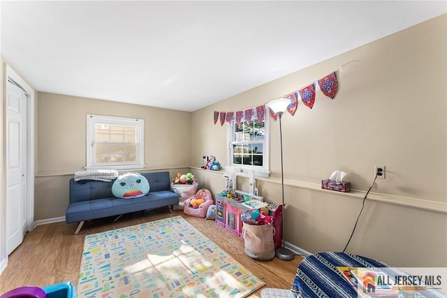 game room featuring baseboards and wood finished floors