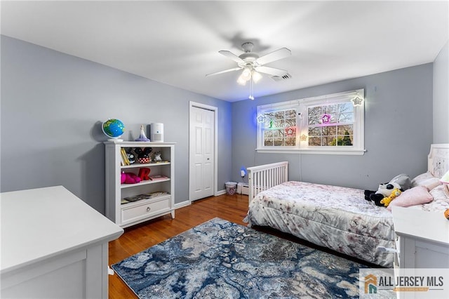 bedroom with visible vents, baseboards, a ceiling fan, and wood finished floors