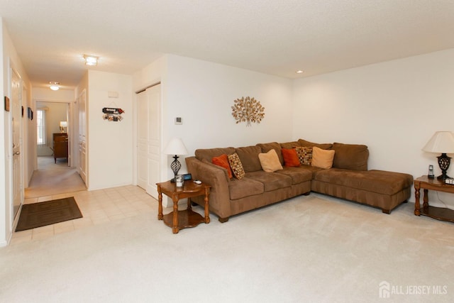 carpeted living room with a textured ceiling