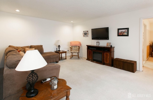 living room featuring light carpet and a textured ceiling