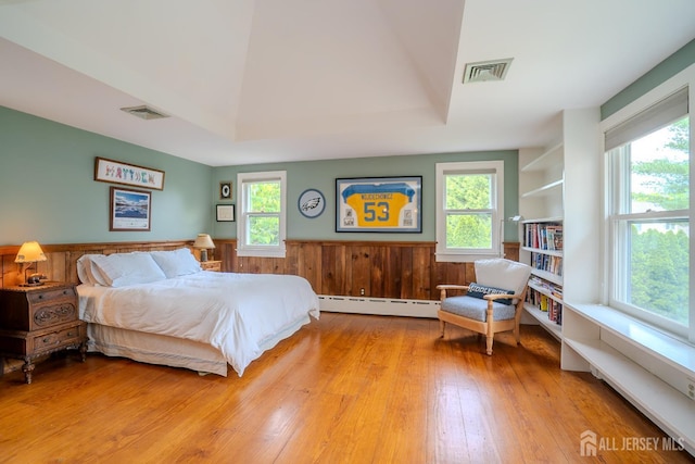 7 Finch Ct, West Windsor, NJ 08550 - bedroom featuring baseboard heating, wood finished floors, and a wainscoted wall
