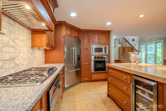 7 Finch Ct, West Windsor, NJ 08550 - kitchen with appliances with stainless steel finishes, beverage cooler, premium range hood, butcher block countertops, and brown cabinetry