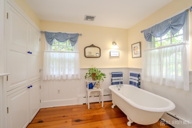 7 Finch Ct, West Windsor, NJ 08550 - bathroom featuring baseboard heating, hardwood / wood-style flooring, healthy amount of natural light, and a wainscoted wall