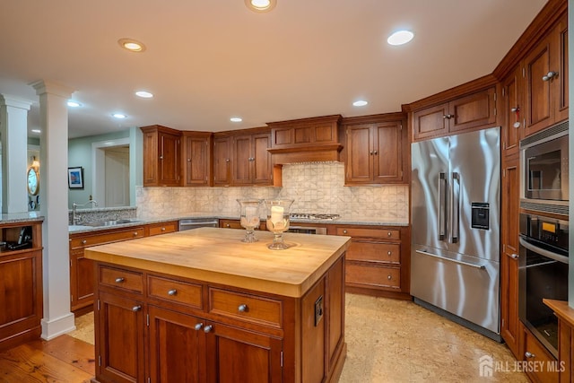 7 Finch Ct, West Windsor, NJ 08550 - kitchen featuring appliances with stainless steel finishes, wood counters, decorative backsplash, ornate columns, and recessed lighting
