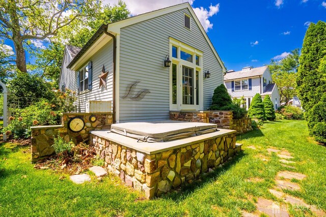 7 Finch Ct, West Windsor, NJ 08550 - back of house with a lawn, a covered hot tub, and stone siding