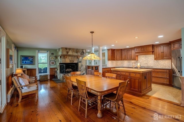 7 Finch Ct, West Windsor, NJ 08550 - dining space with light wood-style flooring, a fireplace, and recessed lighting