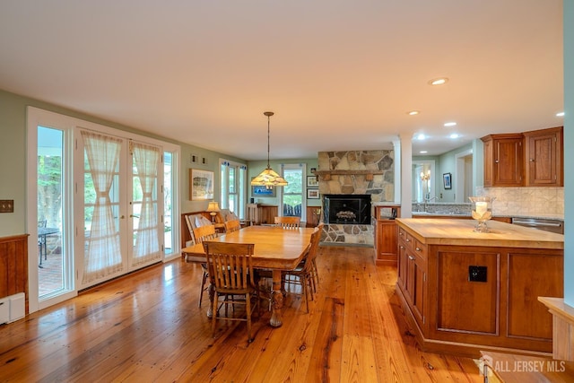 7 Finch Ct, West Windsor, NJ 08550 - dining space featuring light wood finished floors, a stone fireplace, french doors, and recessed lighting