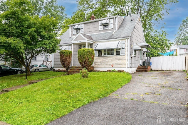 115 W Woodbridge Ave W, Iselin, NJ 08830 - view of front of house with a chimney, stone siding, roof with shingles, and driveway