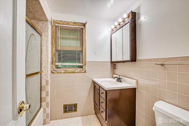 115 W Woodbridge Ave W, Iselin, NJ 08830 - bathroom featuring vanity, tile walls, a wainscoted wall, and tile patterned floors
