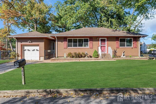 single story home featuring a front yard and a garage