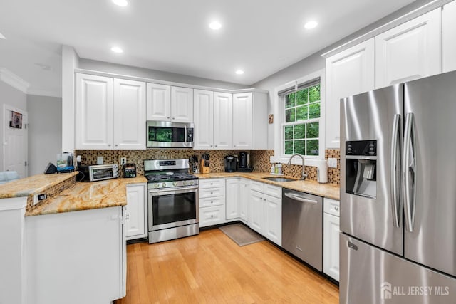 22 Daffodil Way, Old Bridge, NJ 08857 - kitchen featuring stainless steel appliances, a peninsula, white cabinetry, ornamental molding, and recessed lighting