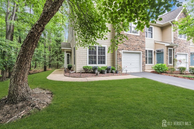 22 Daffodil Way, Old Bridge, NJ 08857 - view of front of home with stone siding, driveway, a front yard, and an attached garage