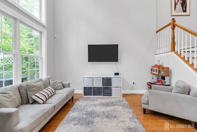 22 Daffodil Way, Old Bridge, NJ 08857 - living room featuring a towering ceiling, stairway, and wood finished floors