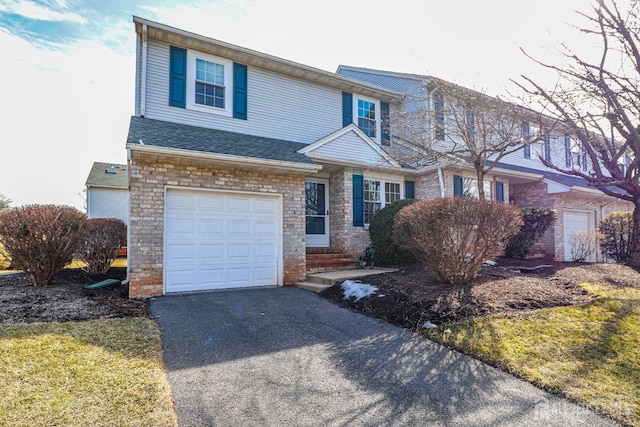 view of front of home featuring aphalt driveway, stone siding, roof with shingles, and an attached garage