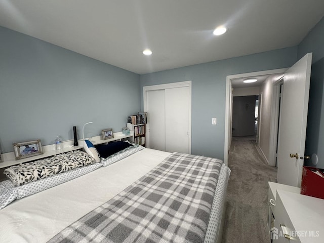 carpeted bedroom featuring a closet and recessed lighting