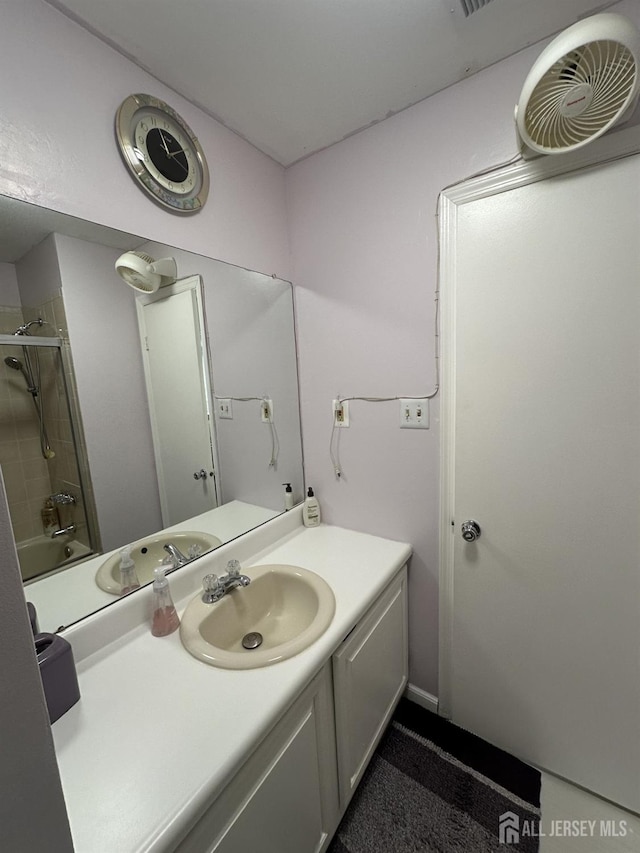bathroom with an enclosed shower and vanity