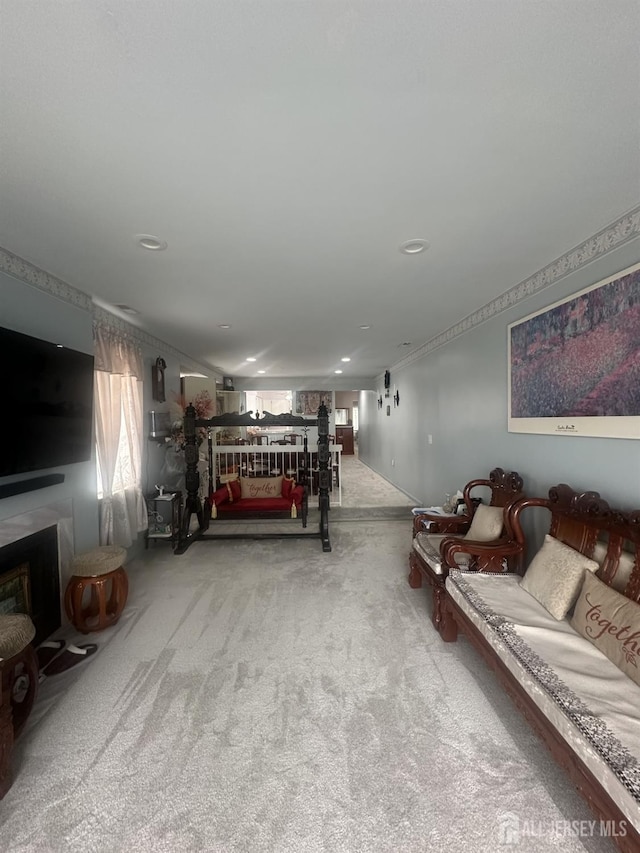 carpeted bedroom with a fireplace and recessed lighting