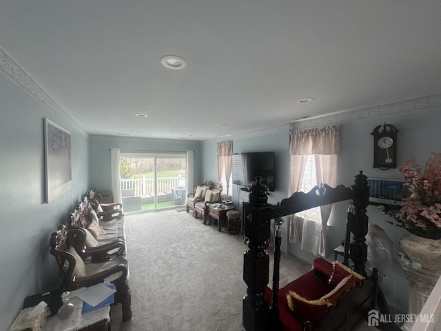 carpeted living area featuring ornamental molding and recessed lighting