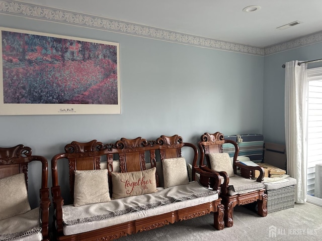 living area featuring visible vents, recessed lighting, and carpet