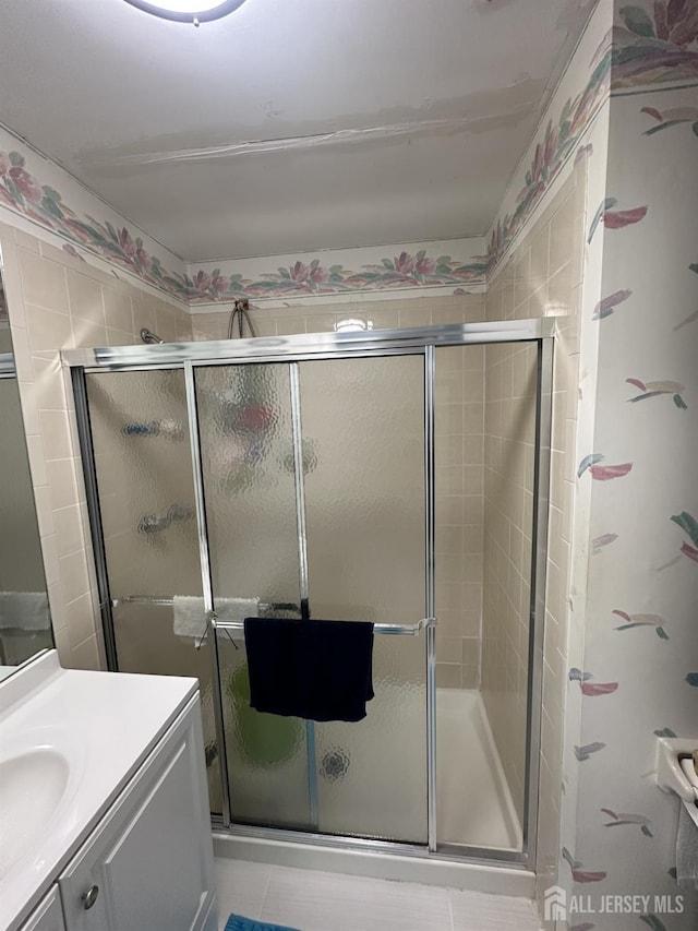 bathroom with vanity and a stall shower