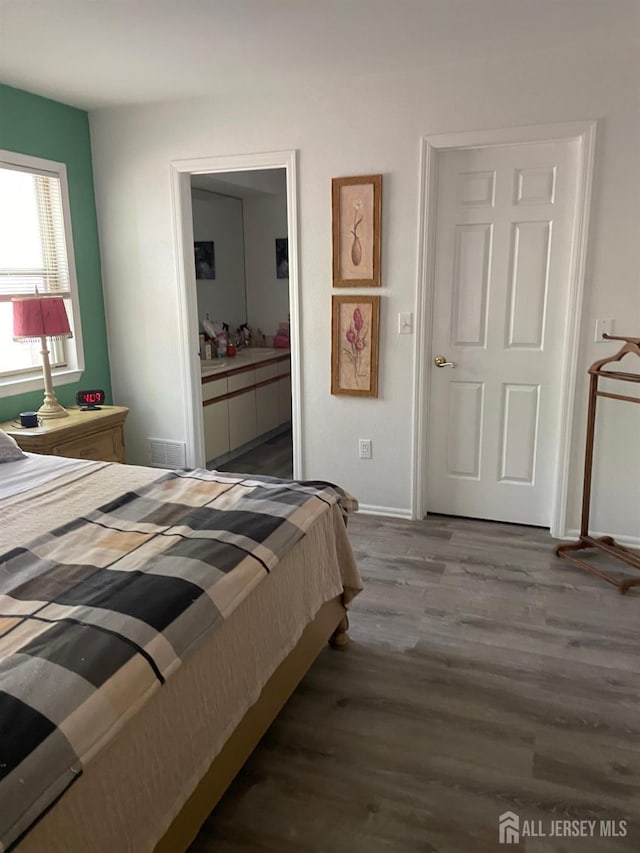 518 Petunia Ln N, Whiting, NJ 08759 - bedroom featuring dark wood-type flooring, baseboards, and connected bathroom
