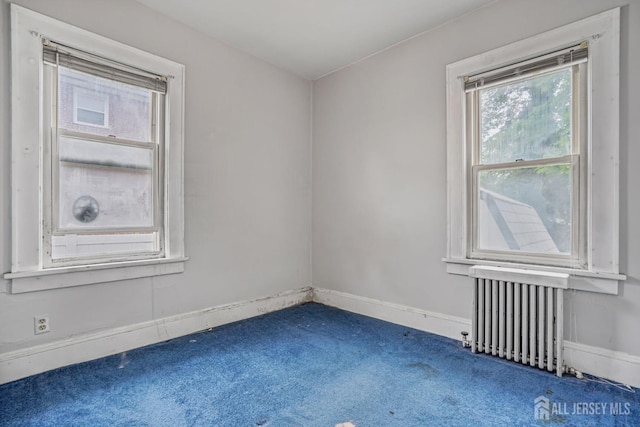 58 Fern St, Edison, NJ 08817 - empty room with radiator heating unit and carpet floors