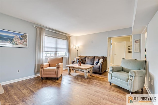 living area with wood finished floors and baseboards