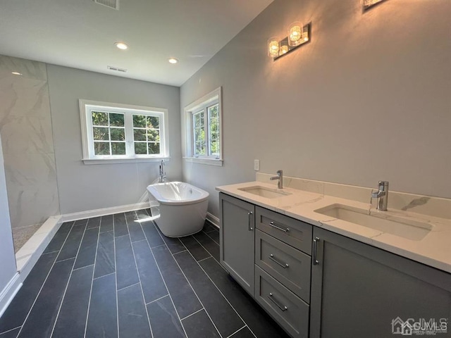 bathroom featuring tile patterned flooring, dual vanity, and independent shower and bath