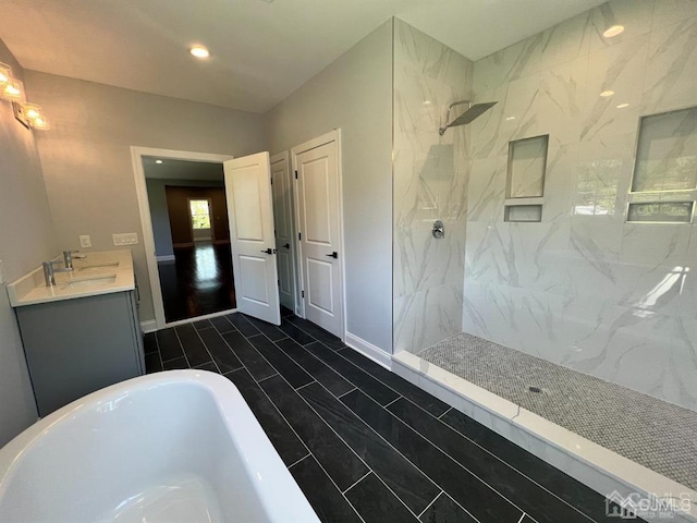 bathroom with independent shower and bath, tile patterned floors, and vanity