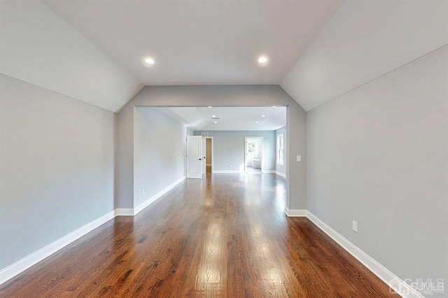 interior space with dark wood-type flooring and lofted ceiling