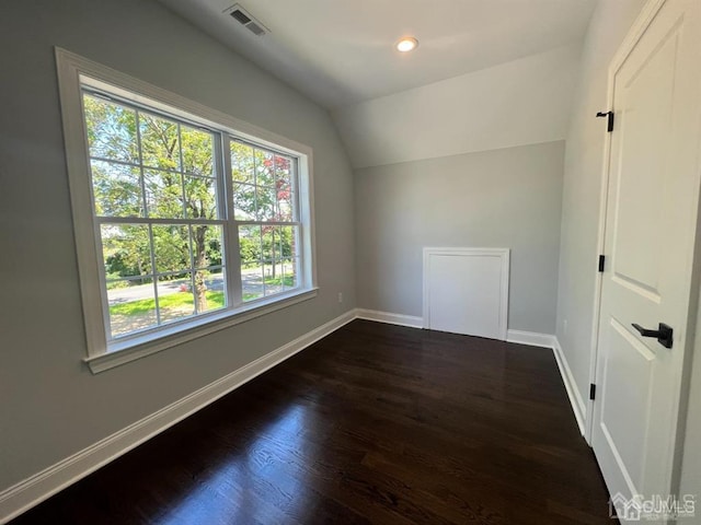 bonus room featuring lofted ceiling and dark wood-type flooring