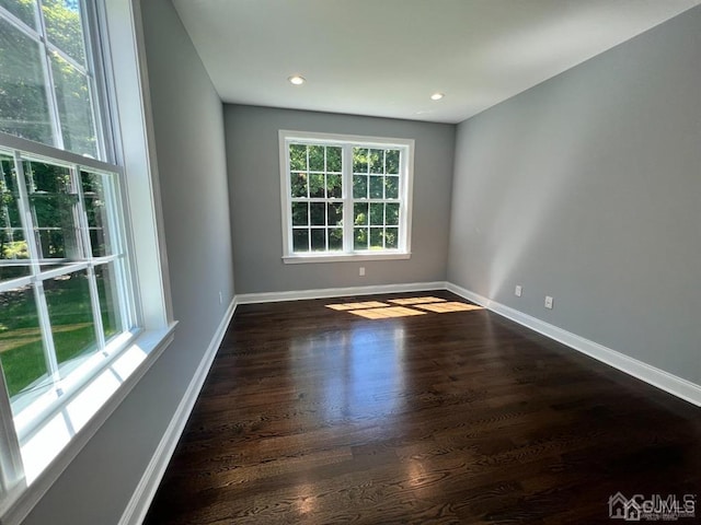 unfurnished room featuring dark hardwood / wood-style flooring