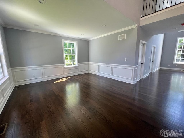 empty room featuring crown molding and dark hardwood / wood-style floors