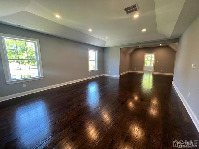 unfurnished room with plenty of natural light and dark hardwood / wood-style floors