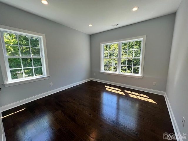 spare room with dark hardwood / wood-style flooring