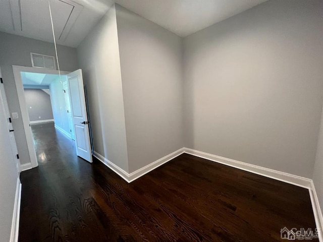 corridor with dark hardwood / wood-style floors