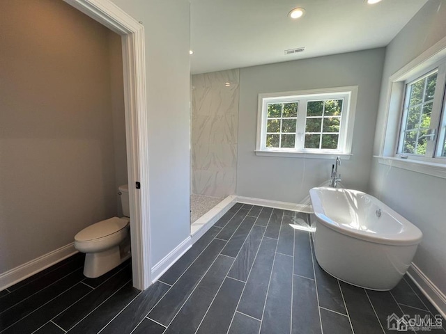 bathroom featuring walk in shower and toilet